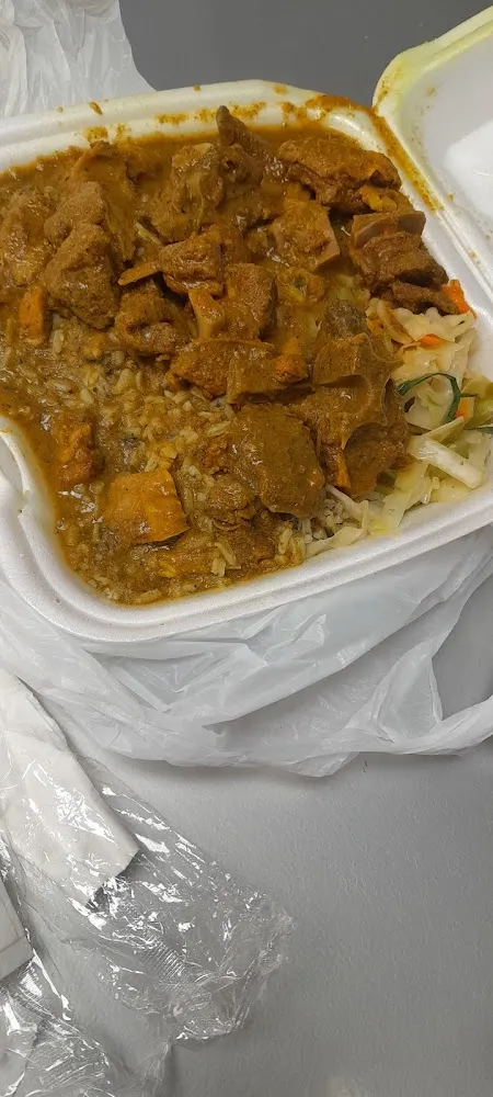 Curry Goat Spinach Rice and Cabbage